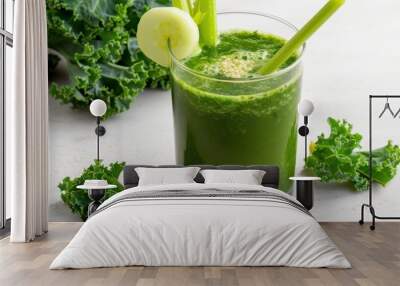 A glass of green juice with a cucumber slice in it Wall mural