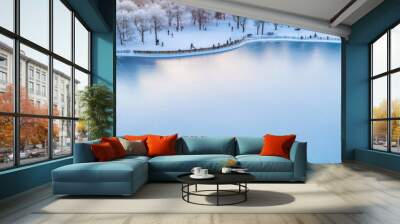 A serene snowy landscape with a tranquil frozen lake and frosty trees. Wall mural