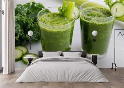 Two glasses of green juice with celery and cucumber slices on the table Wall mural