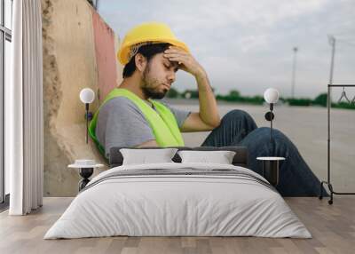 Asian man construction worker feeling stress and depressed about his job Wall mural