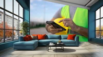 construction workers male hands using smartphone at the construction site Wall mural