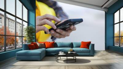 construction working touch screen smart phone at construction site Wall mural