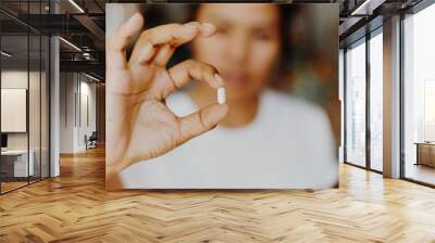 woman holding pills in one hand Wall mural