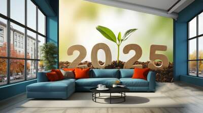 Business holding wooden block showing year 2025 with growing tree Wall mural