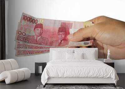 hands giving out one hundred thousand money on white background, rupiah money, hand showing 100000 rupiah money Wall mural