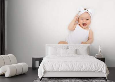 smiling newborn baby on a white bed at home, the concept of a happy, healthy baby, a place for text Wall mural