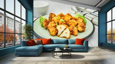 Vegan cauliflower buffalo wings on white wooden table.Tasty vegetarian food top view. crispy fried cauliflower bites Wall mural