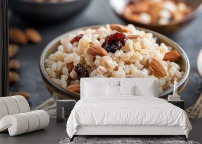 Nutritious bowl of whole grain rice with almonds and dried cranberries, perfect for a healthy breakfast or snack. Wall mural