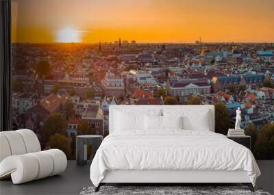 Beautiful evening panorama of Amstedam city looking towards the west with beautiful sunset and sun setting down over Amsterdam. Drone view. Wall mural