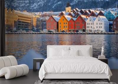 Bergen waterfront cityscape.with pucturesque bryggen houses in colorful theme in front of the wharf. Looking from across the bay on cold winter snow day. Wall mural