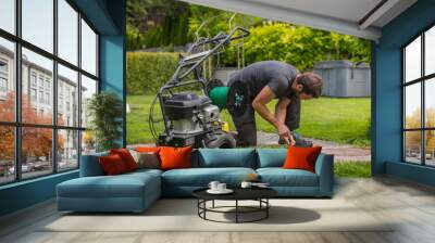 Cable laying machine with an operator used to put down cables for robotic lawnmowers. Inserting cable in the ground as a guide cable for robotic lawnmower Wall mural