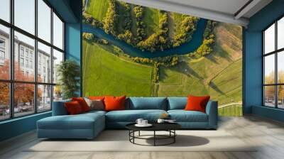 River bend surrounded by fields from bird's eye view. Wall mural