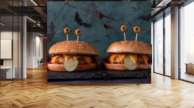 Two funny monster chicken burger with toast cheese, ketchup, cucumber and olive eyes. Food for Halloween Wall mural