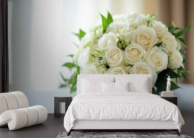 A beautiful bridal bouquet featuring white roses and greenery arranged elegantly indoors Wall mural