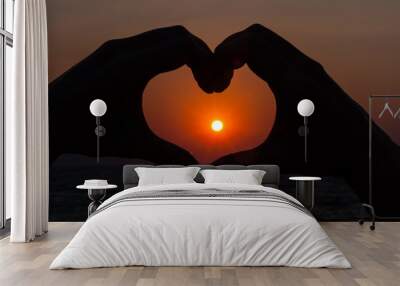 Silhouette heart with sunrise behind Wall mural