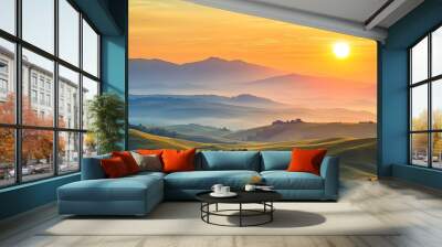 A beautiful sunrise illuminates rolling hills and distant mountains, casting soft light over a peaceful and misty landscape. Wall mural