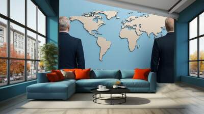 Two business professionals analyze a world map, symbolizing global strategy and collaboration in a corporate environment. Wall mural