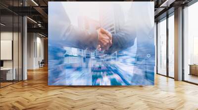 Double exposure businessman handshake to show cooperate in business with city scape building  background. Wall mural