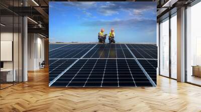 Engineers walking on roof inspect and check solar cell panel by hold equipment box and radio communication ,solar cell is smart grid ecology energy sunlight alternative power factory concept Wall mural