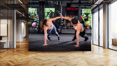 Portrait young fitness woman under push up exercise at gym. she exercise for strong ,make muscle body building and good healthy concept Wall mural