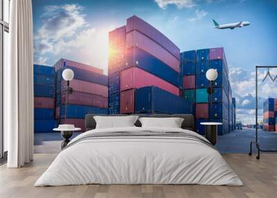 The dock logistics import export and folklife truck transport industry of Container Cargo freight ship and Cargo plane at seaport on blue sky. Wall mural