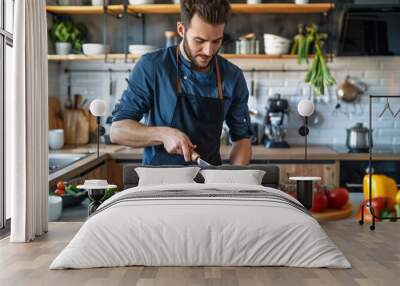 Young Man Cooking Vegetables in Kitchen Wall mural