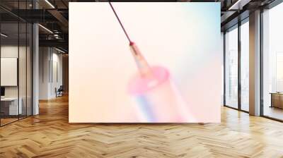 drop of vaccine on the needle of a disposable syringe on a light background. Wall mural