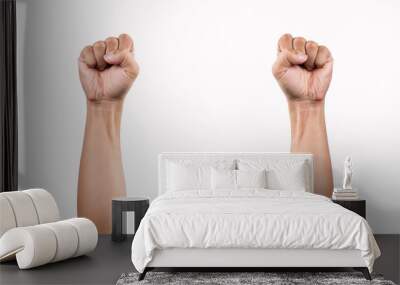 Clinched fist raised up on white background. two arm on white Wall mural