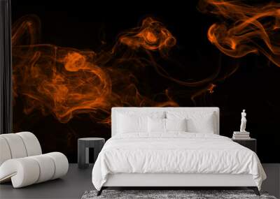 Fluffy puffs of orange smoke and fog on black background, fire design Wall mural