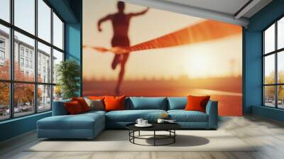 Athlete in full sprint crossing finish line, showcasing determination and speed, vibrant energy radiating from the moment of victory. Wall mural