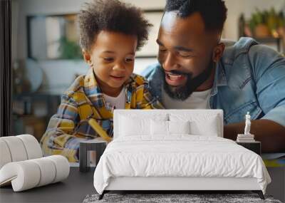 A child drawing a picture of themselves as a football player on a piece of paper, with their father proudly looking  Wall mural