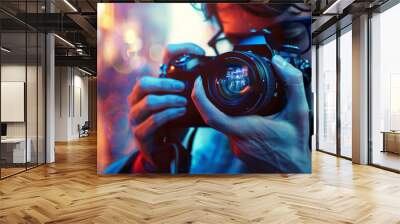 A photographer wearing casual attire and holding a realistic camera. Wall mural