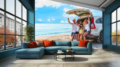 Happy asian family at consisting father, mother, son and daughter having fun in summer vacation on the beach Wall mural