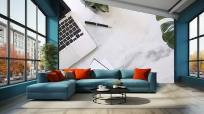 A workspace featuring a laptop, a pad of paper, and a pen, ready for a remote job or homework session, with a clean and contemporary design Wall mural