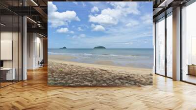 Two islands and white sand beach on sunny day with clear blue sky and clouds Wall mural