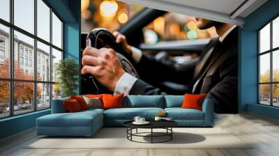 A businessman in a suit driving a car, showcasing a professional and urban lifestyle with elegance and confidence. Wall mural