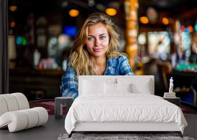 A confident woman playing poker at a casino table filled with chips and cards. She smiles casually in a relaxed and friendly atmosphere. Wall mural