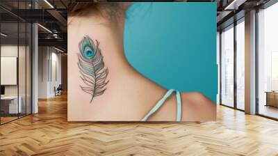 An elegant peacock feather tattoo, delicately placed on the back of the neck, symbolizing beauty and grace, against a solid teal background. Wall mural