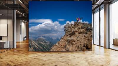 Group of friends hikers on mountain top against blue sky and clouds. Colorado. USA Wall mural