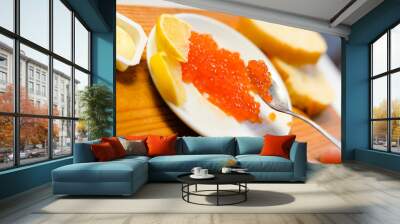 Red caviar, lemon and bread on wooden board white table background Wall mural