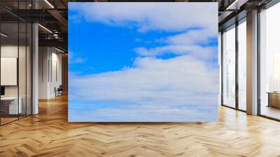 Image of a partly cloudy and partly clear sky during the day Wall mural