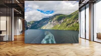 Impression from cruise ship on the way through Geiranger fjord in Norway at sunrise in summer Wall mural