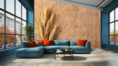 Ears of wheat on a burlap background Wall mural