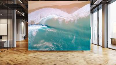 Ocean waves on the beach as a background. Beautiful natural summer vacation holidays background. Aerial top down view of beach and sea with blue water waves Wall mural