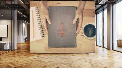 Vintage tone of wooden Christian cross on the Bible during praye Wall mural