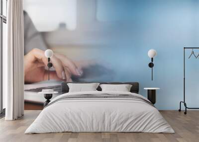 Business woman hands typing on laptop computer keyboard Wall mural