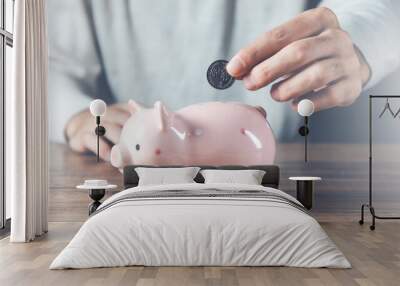 man hand coins with piggy bank on desk Wall mural