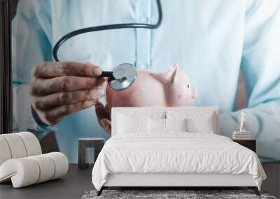 man hand  piggy bank with stethoscope Wall mural