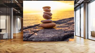 stones stacked on top of each other on the beach Wall mural