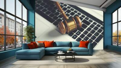 Wooden judge gavel on keyboard laptop computer Wall mural